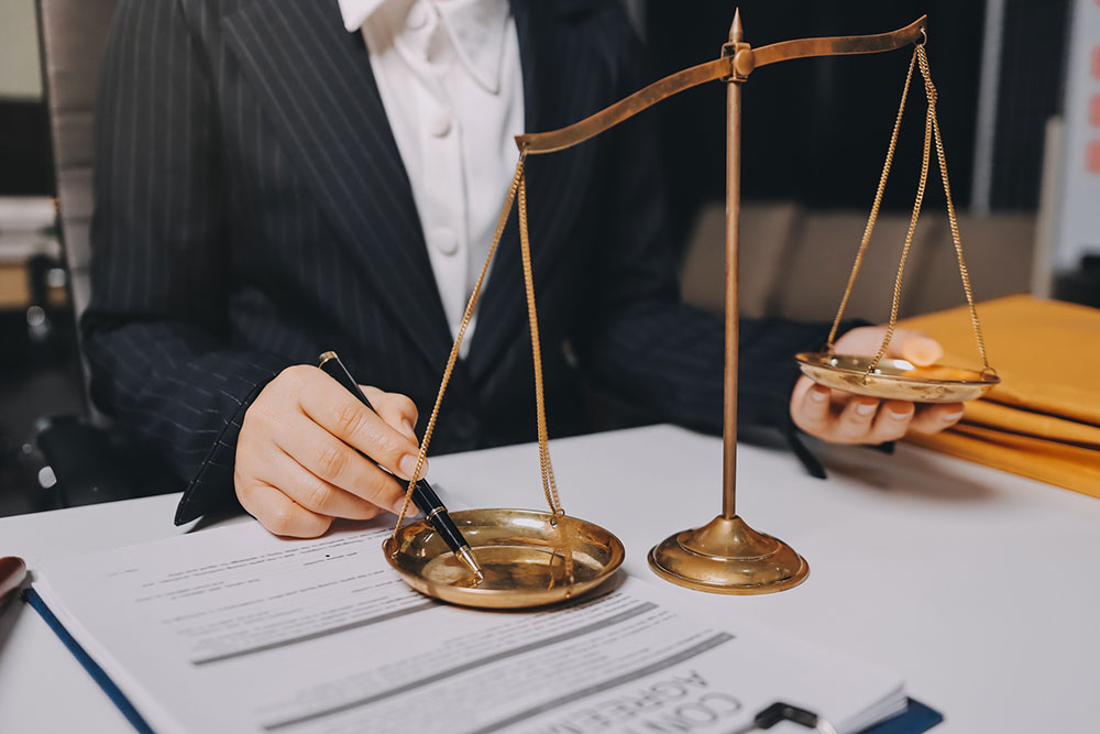 Businesswoman holding scales of justice in an office, symbolizing Florida whistleblower protections for employees
