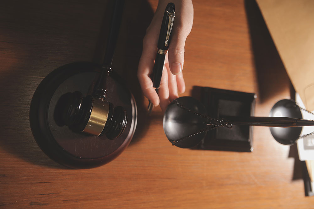 Law books and scales of justice on a desk representing Florida whistleblower protection laws