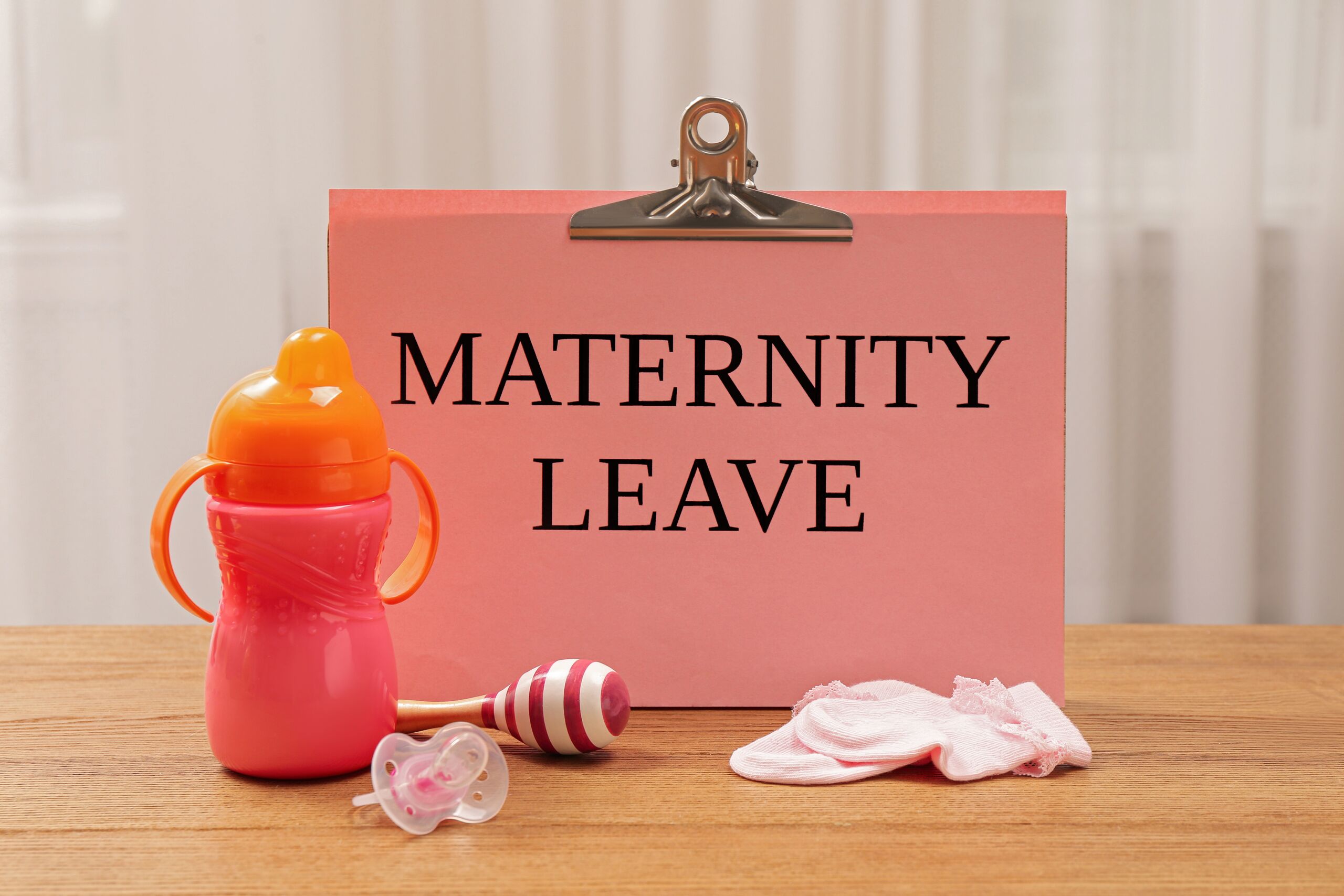 Maternity leave sign with baby items, representing pregnancy accommodations and light duty rights under the PWFA in Florida